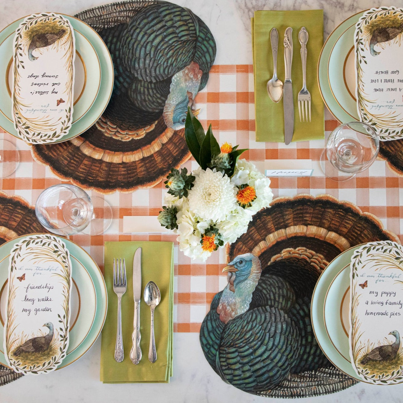 The Die-cut Heritage Turkey Placemat under an elegant Thanksgiving table setting for four, from above.