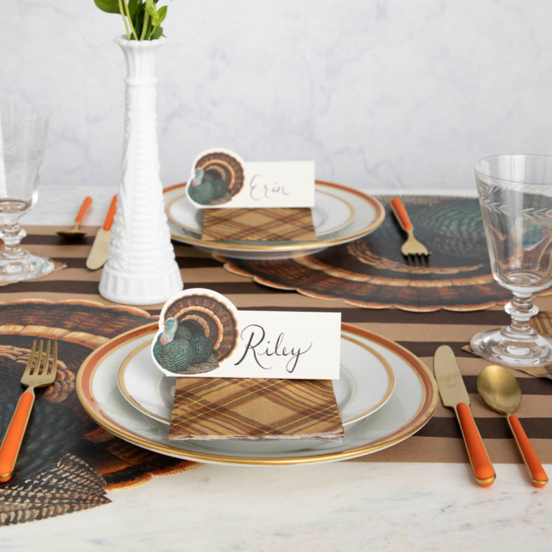 A rustic Thanksgiving tablescape featuring Heritage Turkey Place Cards standing on each plate.