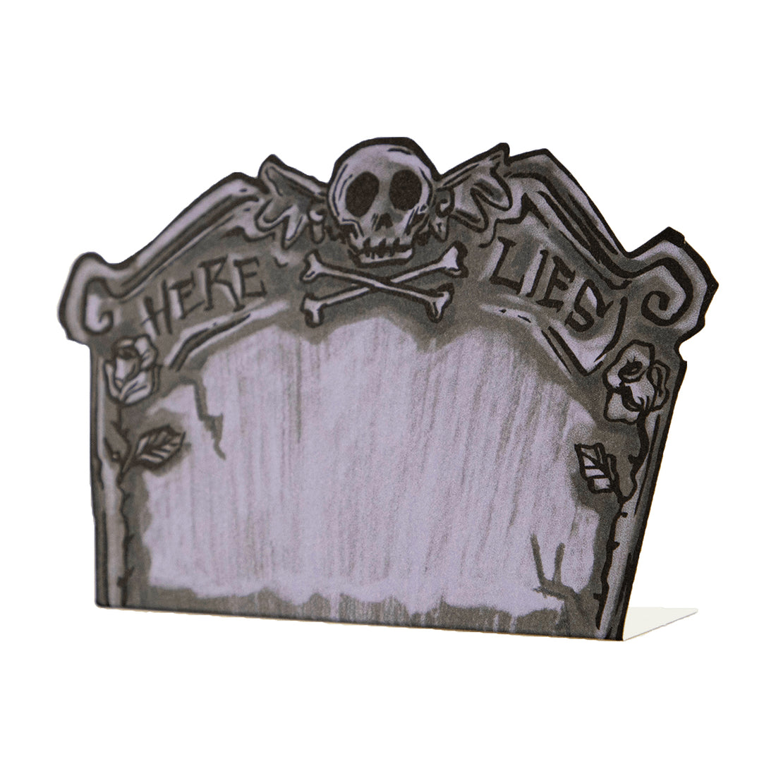 A die-cut freestanding place card depicting a spooky illustrated tombstone in gray with black linework, reading &quot;HERE LIES&quot; across the top with a skull and crossbones, and a blank gray area in the middle for personalization.