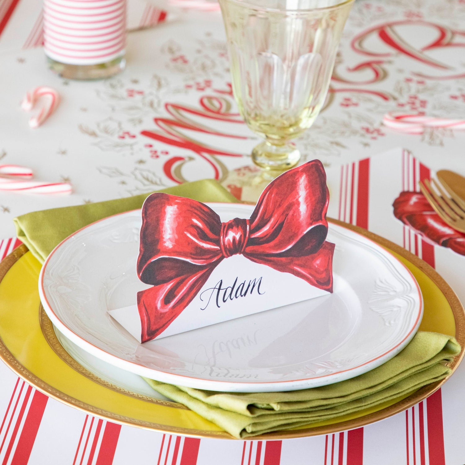 The Bow Place Card resting on a plates with a napkin in between.