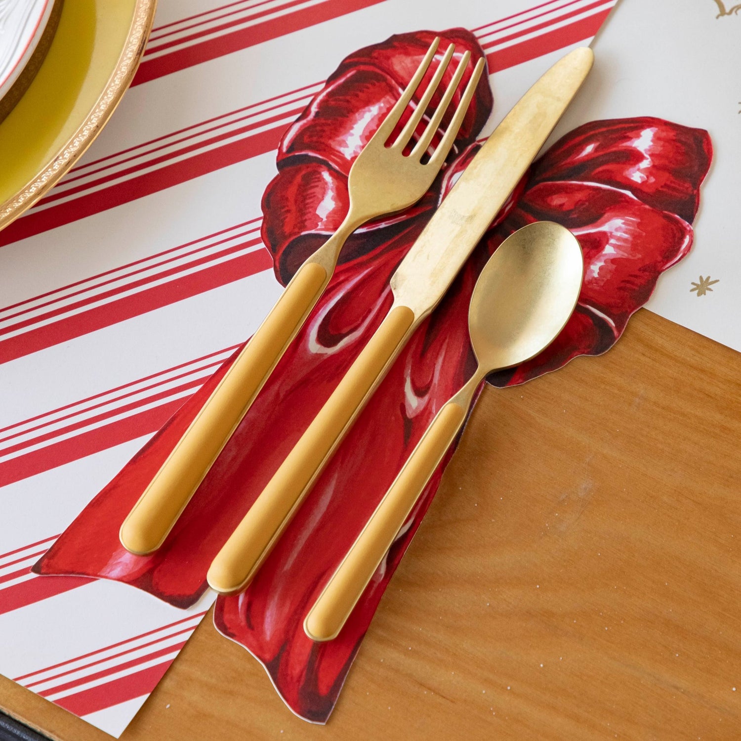 The Bow Table Accent with gold flatware on top.