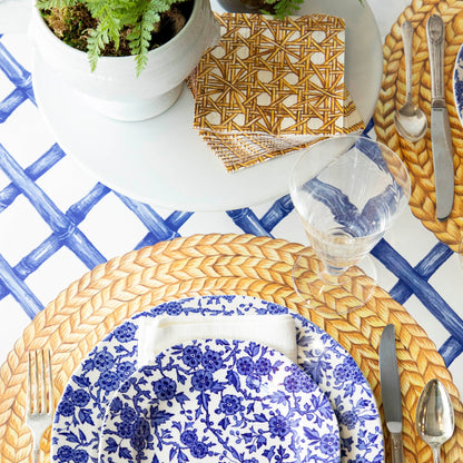 A blue and white table setting with a Hester &amp; Cook Blue Lattice Runner and a plant on it, perfect for celebrations.