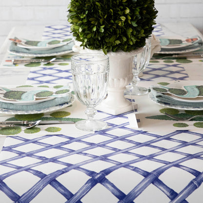A Hester &amp; Cook Blue Lattice Runner with a potted plant on it.