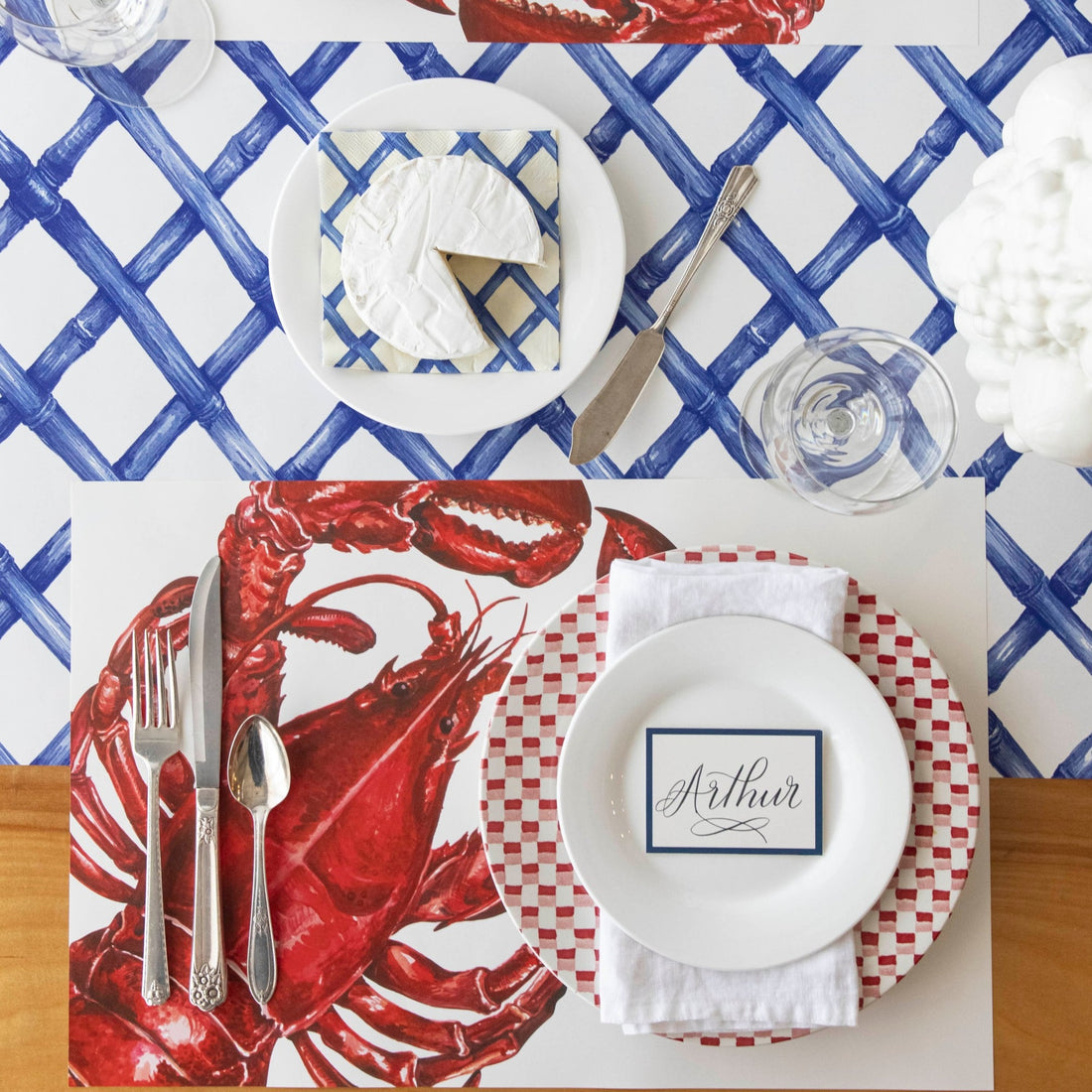 The Maine Lobster Placemat under a nautical themed place setting, from above.