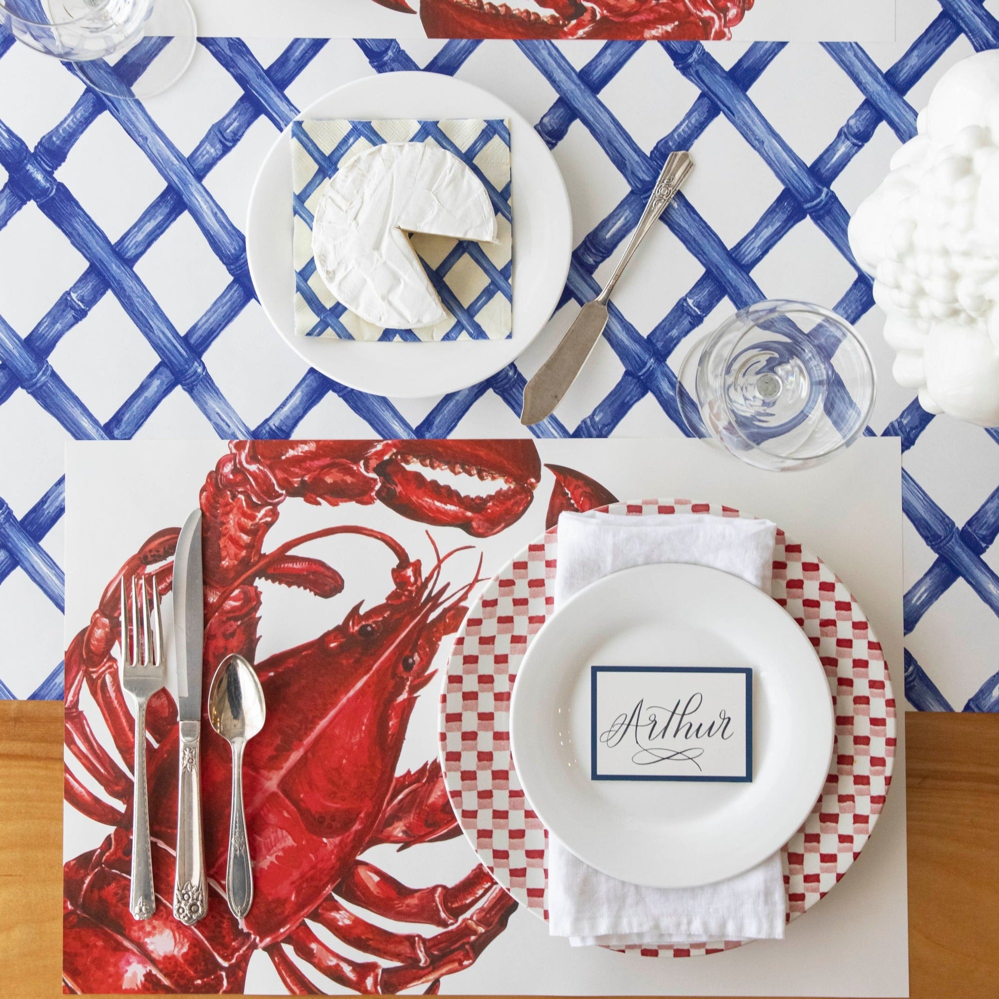 A nautical-themed drawing of a Maine Lobster Placemat by Hester &amp; Cook on a white background.