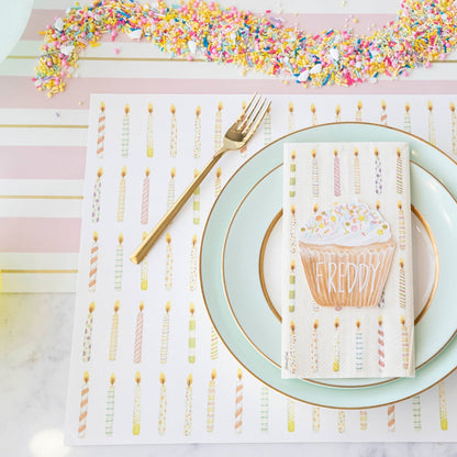 A Pink &amp; Gold Awning Stripe Runner birthday table setting with candles and confetti from Hester &amp; Cook.