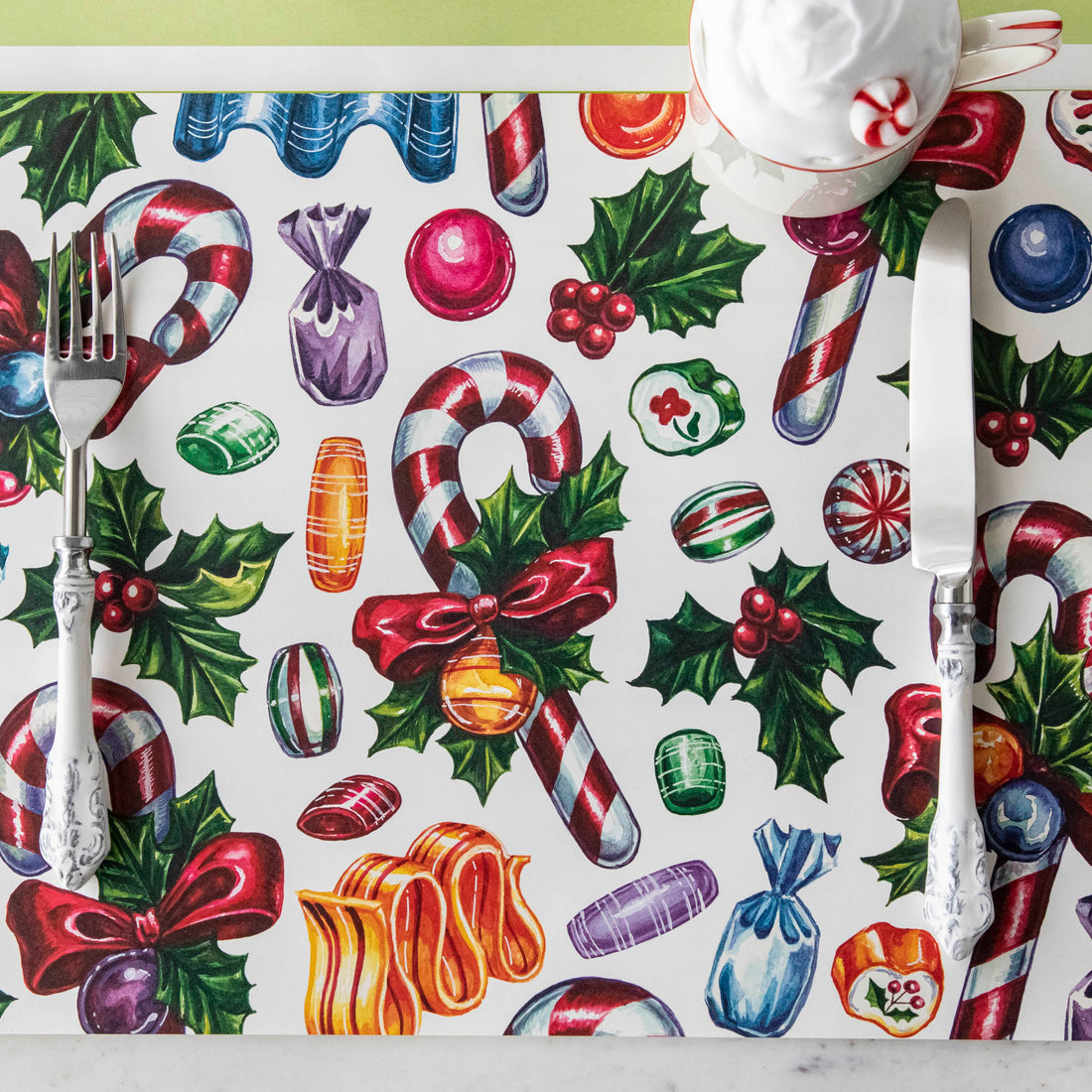 The Candy Cane Shoppe Placemat under a festive Christmas-themed place setting.