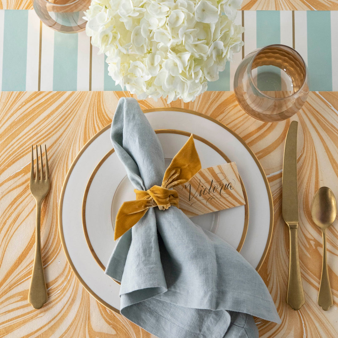 The Gold Leaf Marbled Placemat under an elegant table setting, from above.
