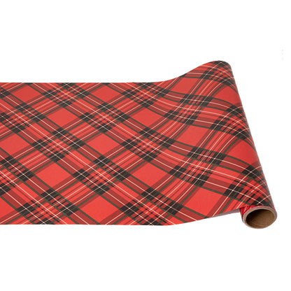 A paper runner roll featuring a large-scale diagonal plaid pattern of black, green and white over bright red.