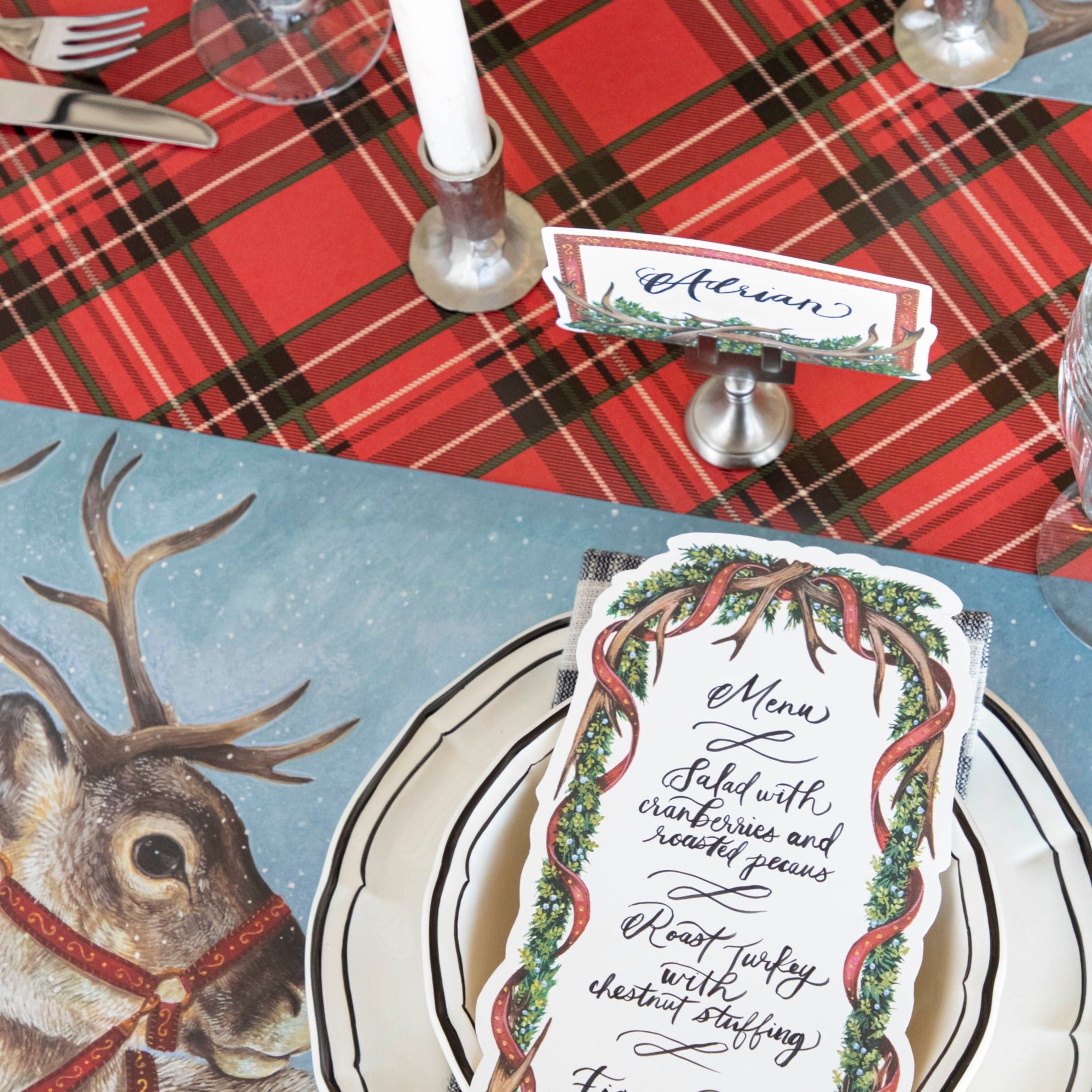 Close-up of the Red Plaid Runner under an elegant Christmas-themed place setting.