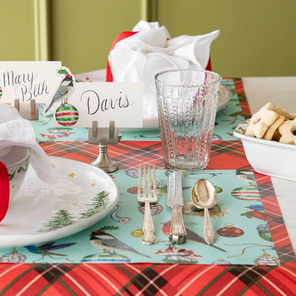 The Christmas Chickadee Place Card on a festive table setting featuring the Baubles and Birds Placemat on the Red Plaid Runner.