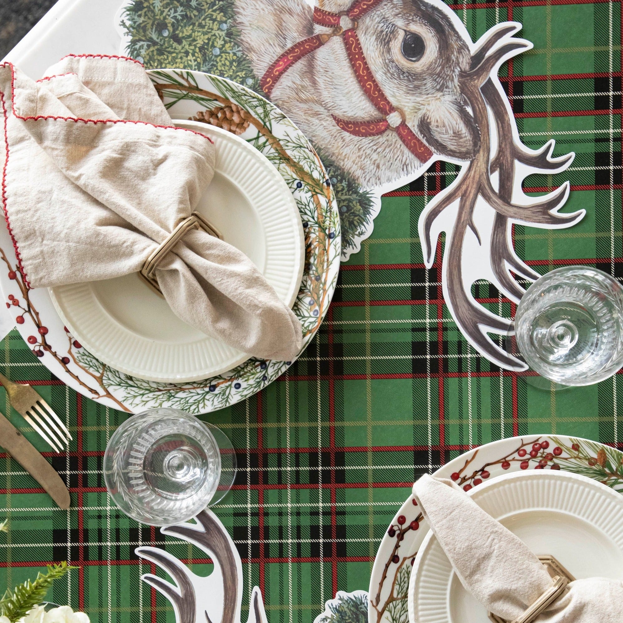 The Green Plaid Runner under a festive Christmas-themed table setting, from above.