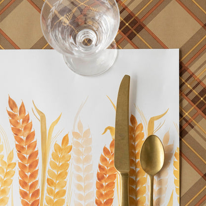 An Autumn Plaid Runner adorned with an iconic plaid design, featuring a gold fork and spoon on it. (Hester &amp; Cook)