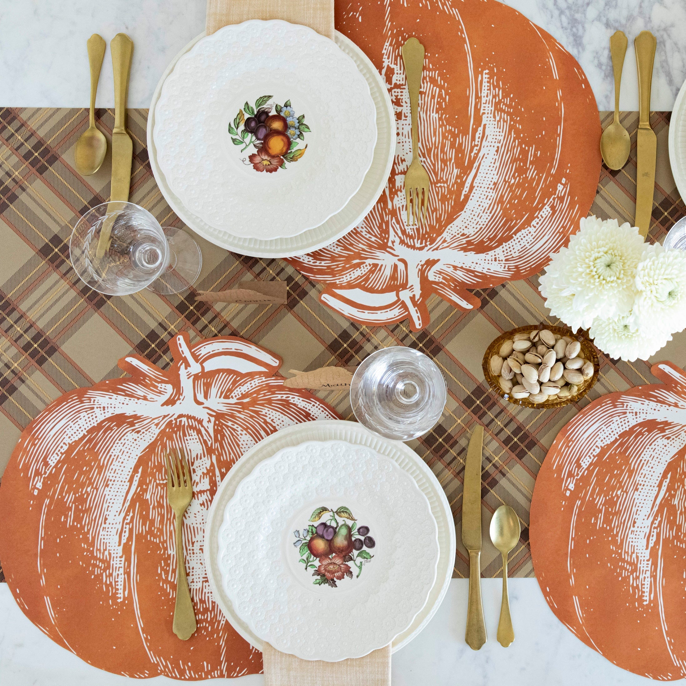 Thanksgiving table setting with Die-cut Pumpkin Placemats and decorative plates.
