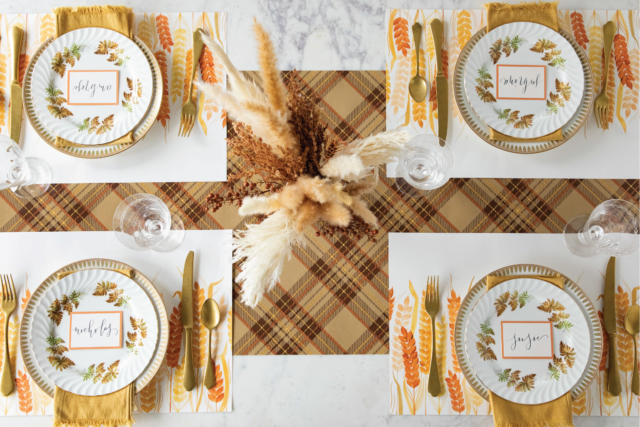 Fall table setting featuring autumn colored placemats that represent harvest time, wheat, and the turning of the season.