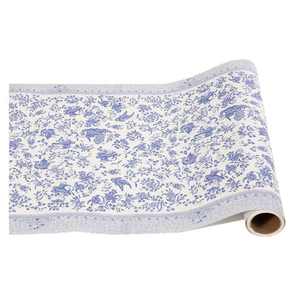 Paper roll featuring a blue bird and floral pattern on a white background, contained on either edge by a detailed floral border, inspired by the ornamental bird pattern from Burleigh.