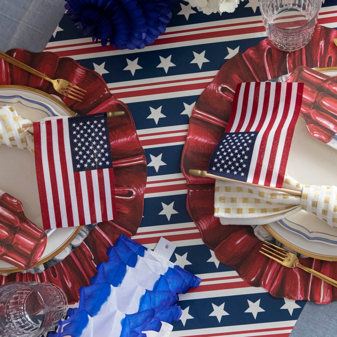 A table with plates and napkins decorated with a Stars and Stripes Runner from Hester &amp; Cook.