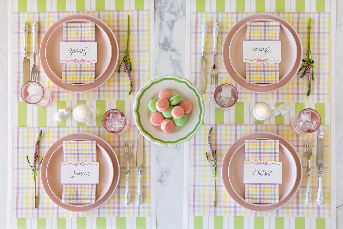 Set table with pink plates, Spring Plaid Placemats and Guest Napkins, Pink Bow Place Cards and decorative elements on the Green &amp; Pink Awning Stripe Runner.