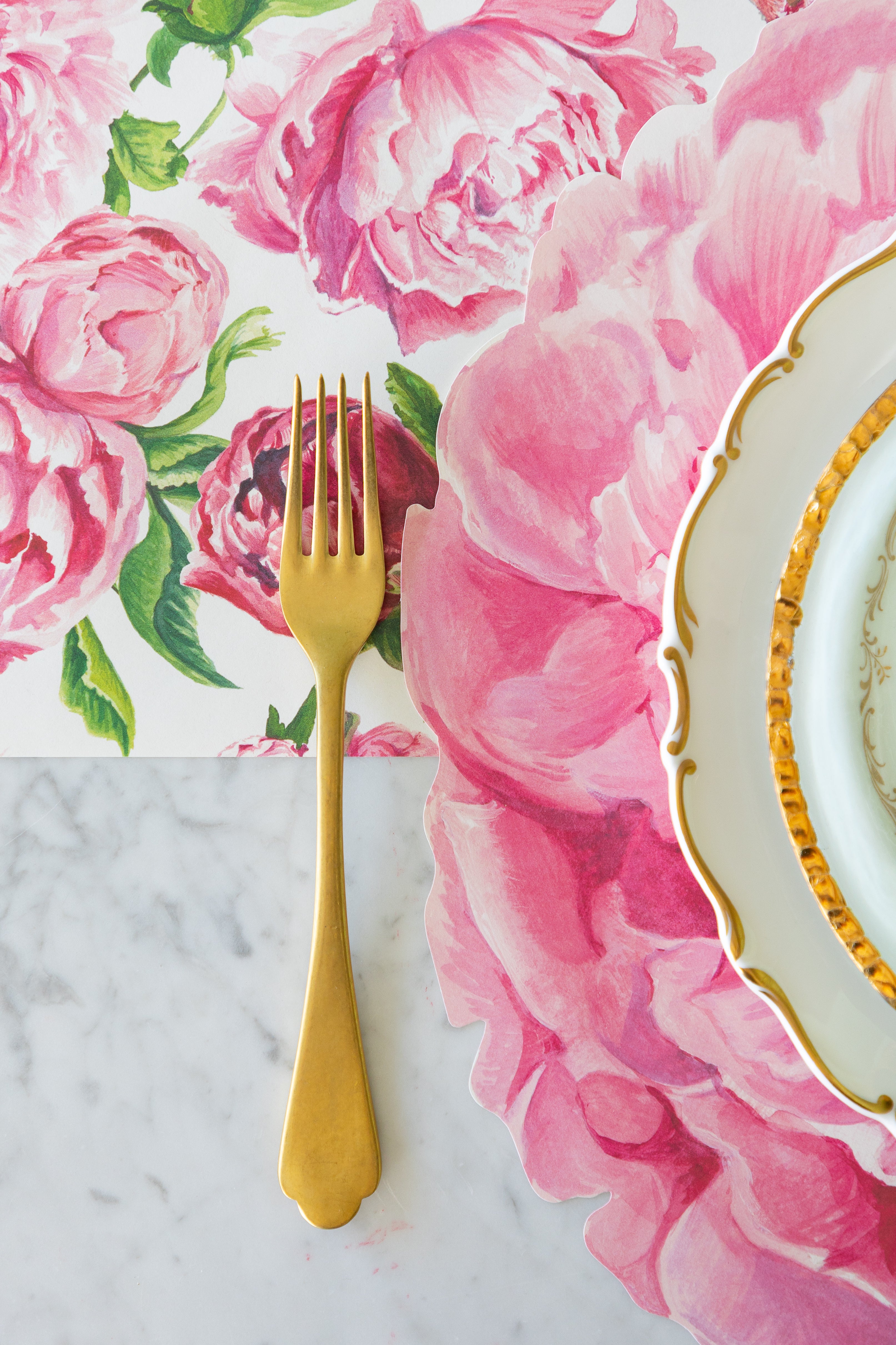 Gold fork next to the Die-cut Peony Placemat on the Peonies in Bloom Runner.