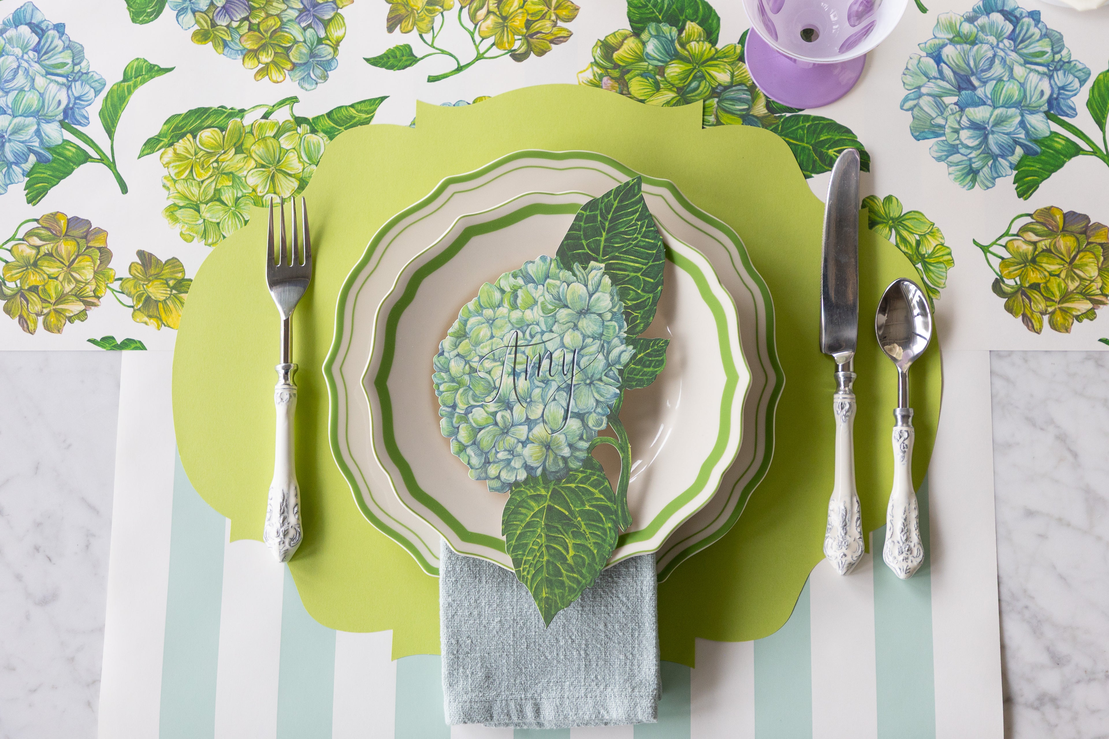 Decorative table setting with Hydrangea Runner, Die-cut Bright Green French Frame Placemat, Hydrangea Table Accent, Green Icing on the Cake Plates and Seafoam Classic Stripe Runner.