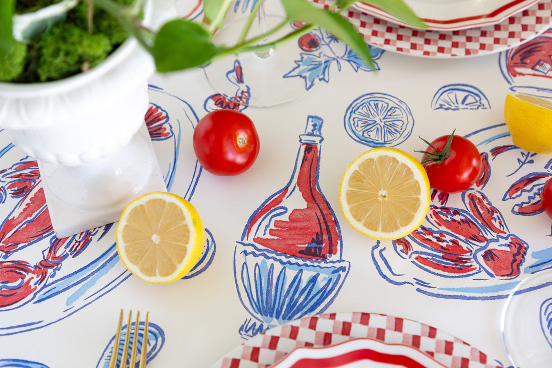 Colorful table runner with a bottle and lemon design, accompanied by lemons and tomatoes.