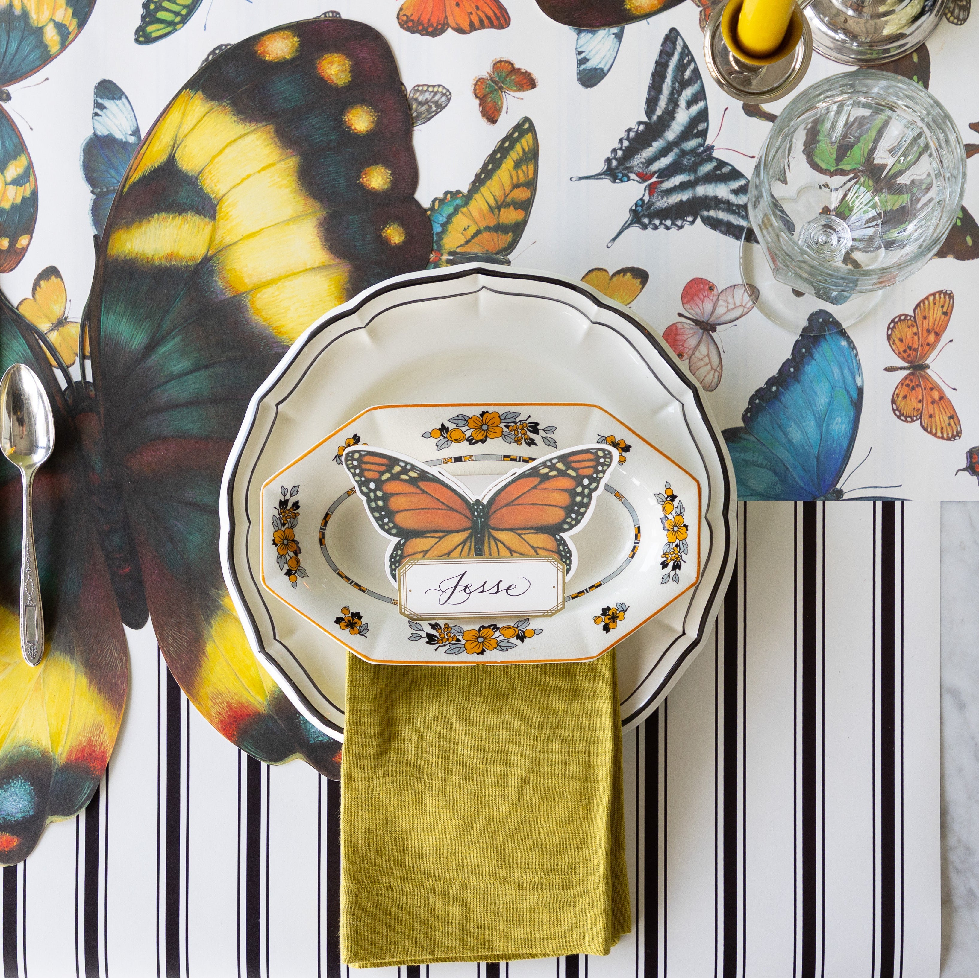 Elegant table setting with the Die-cut Butterfly Placemat, Butterfly Place Card, and dinnerware on the Butterflies and Black Linen Stripe Runner.