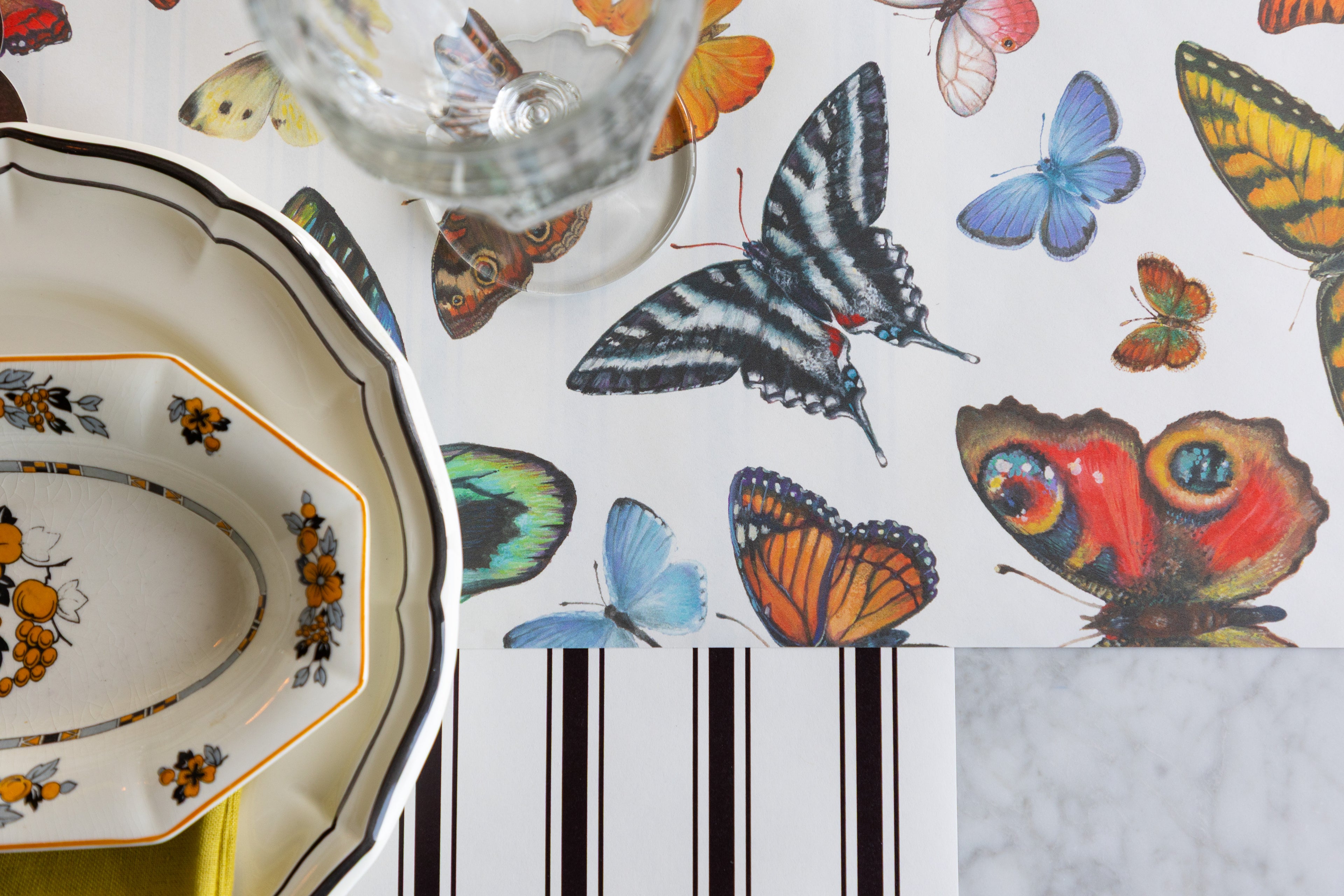 Butterflies Runner on a table setting with the Black Linen Stripe Runner underneath.