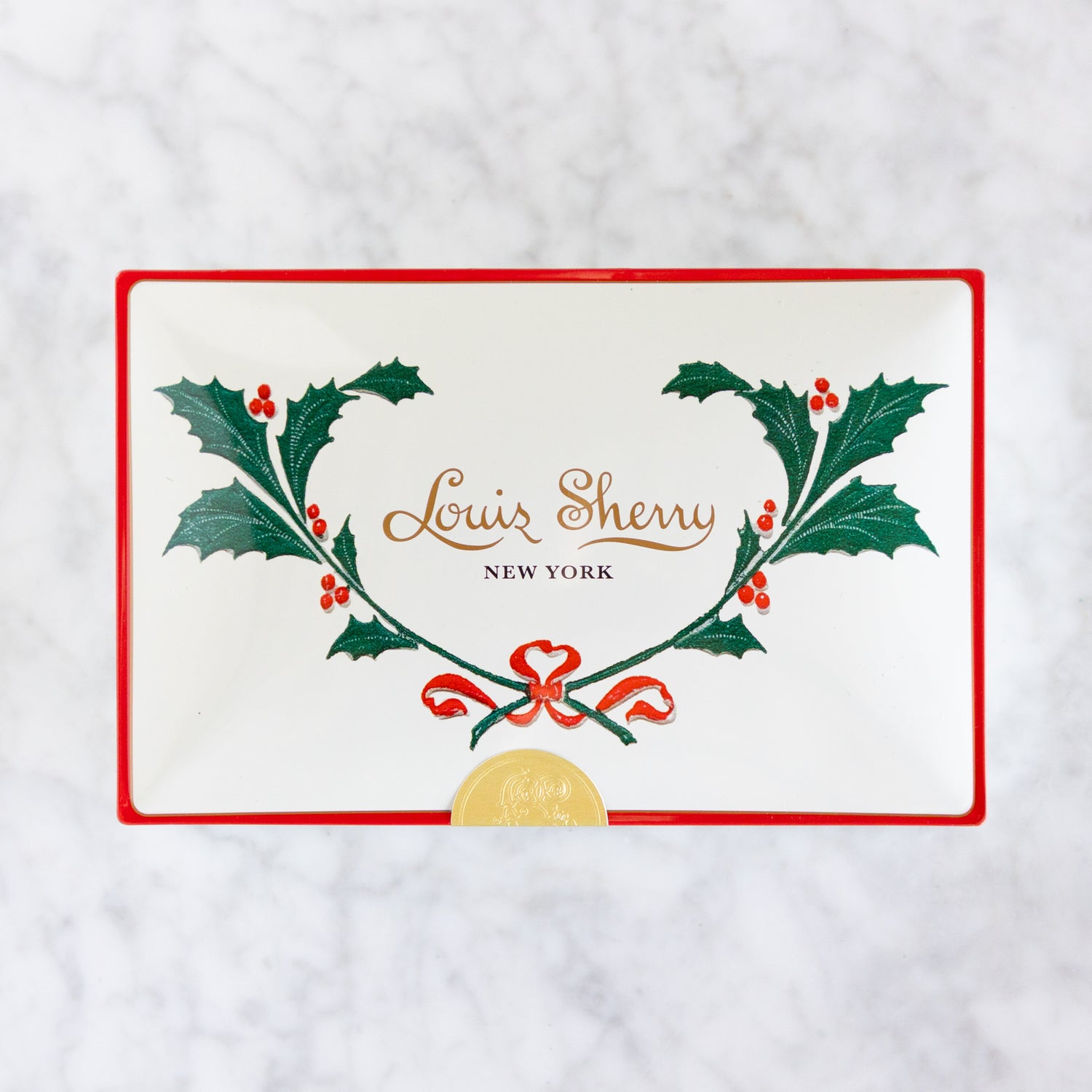 Louis Sherry New York logo with holly leaves and berries on a white background.