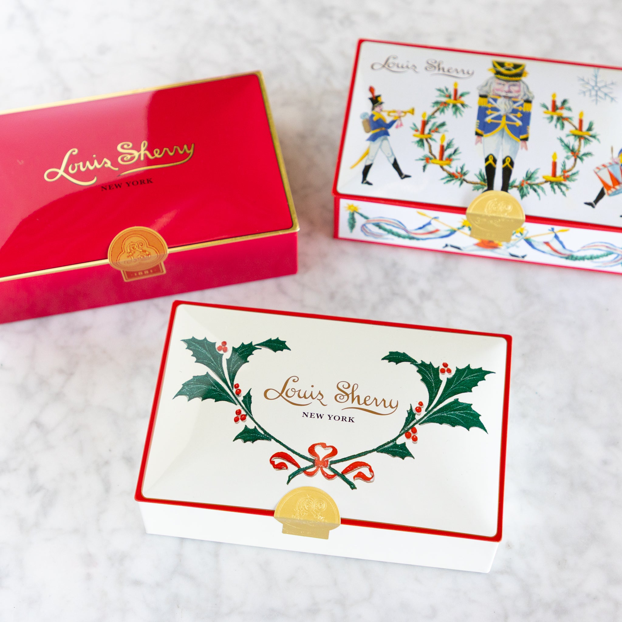 Louis Sherry holiday-themed cards and box on a white background.