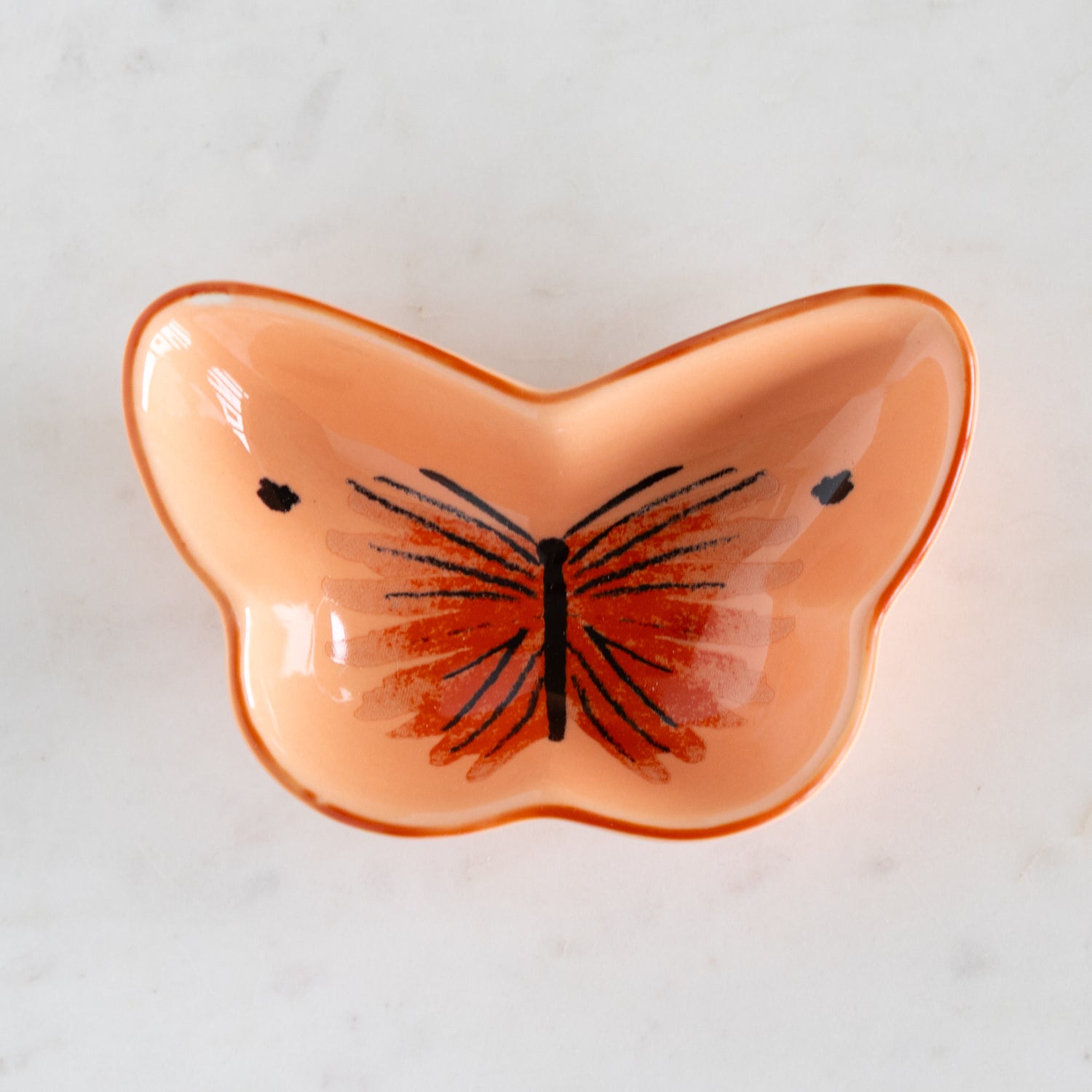 Butterfly-shaped dish with a butterfly design on a light background.