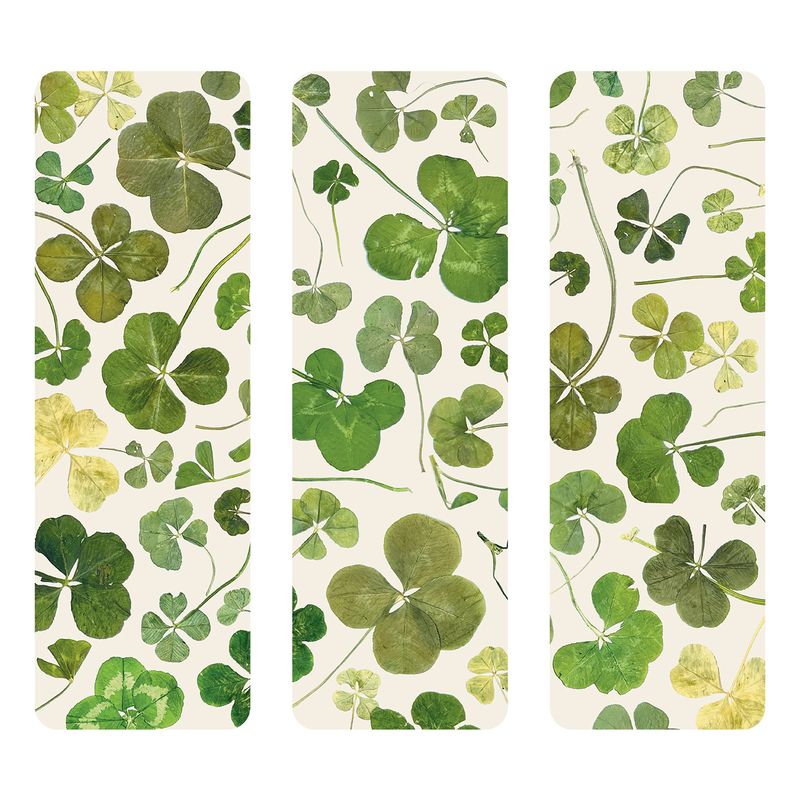 Three bookmarks with green clover leaf patterns on a white background