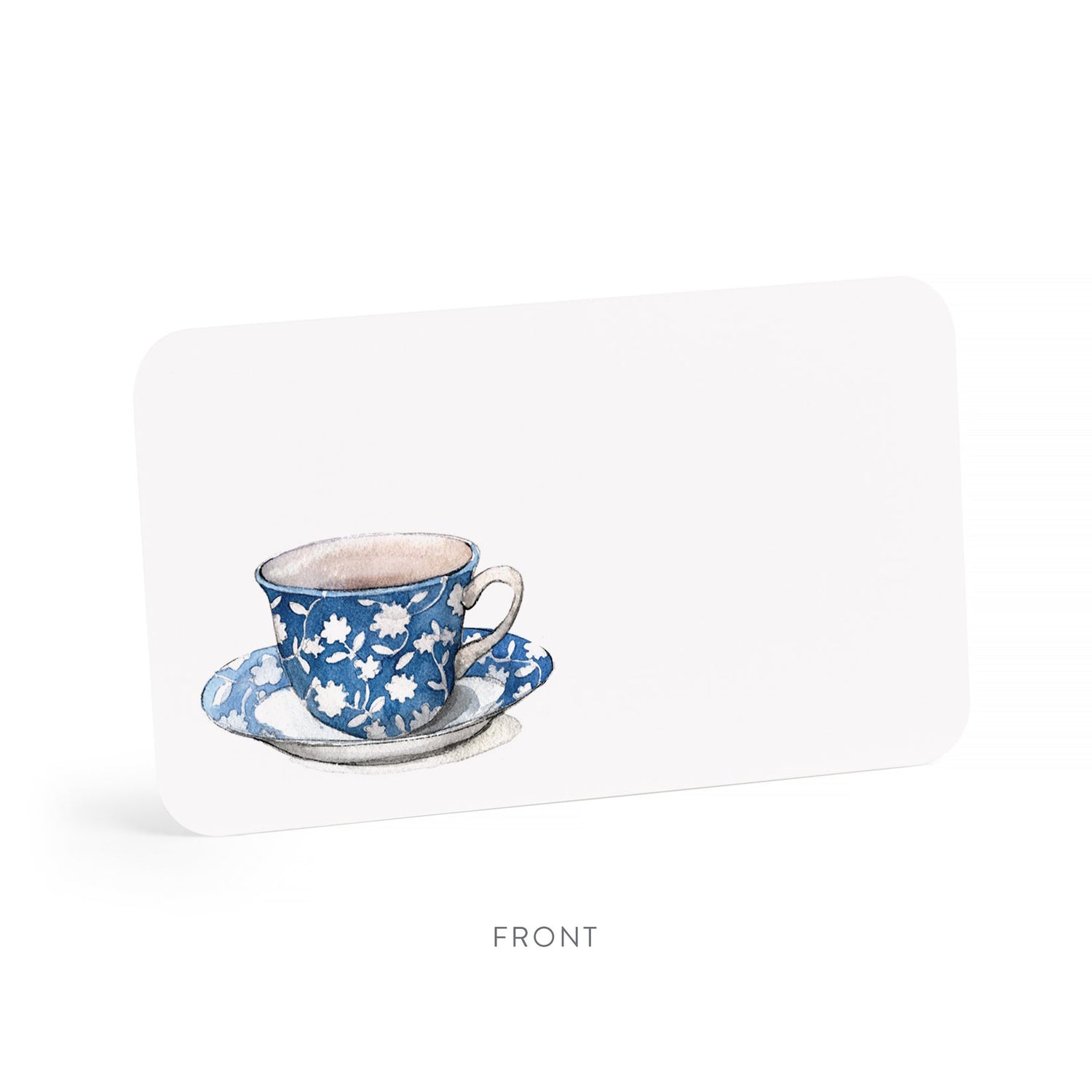 Blue floral teacup and saucer on a white little note.