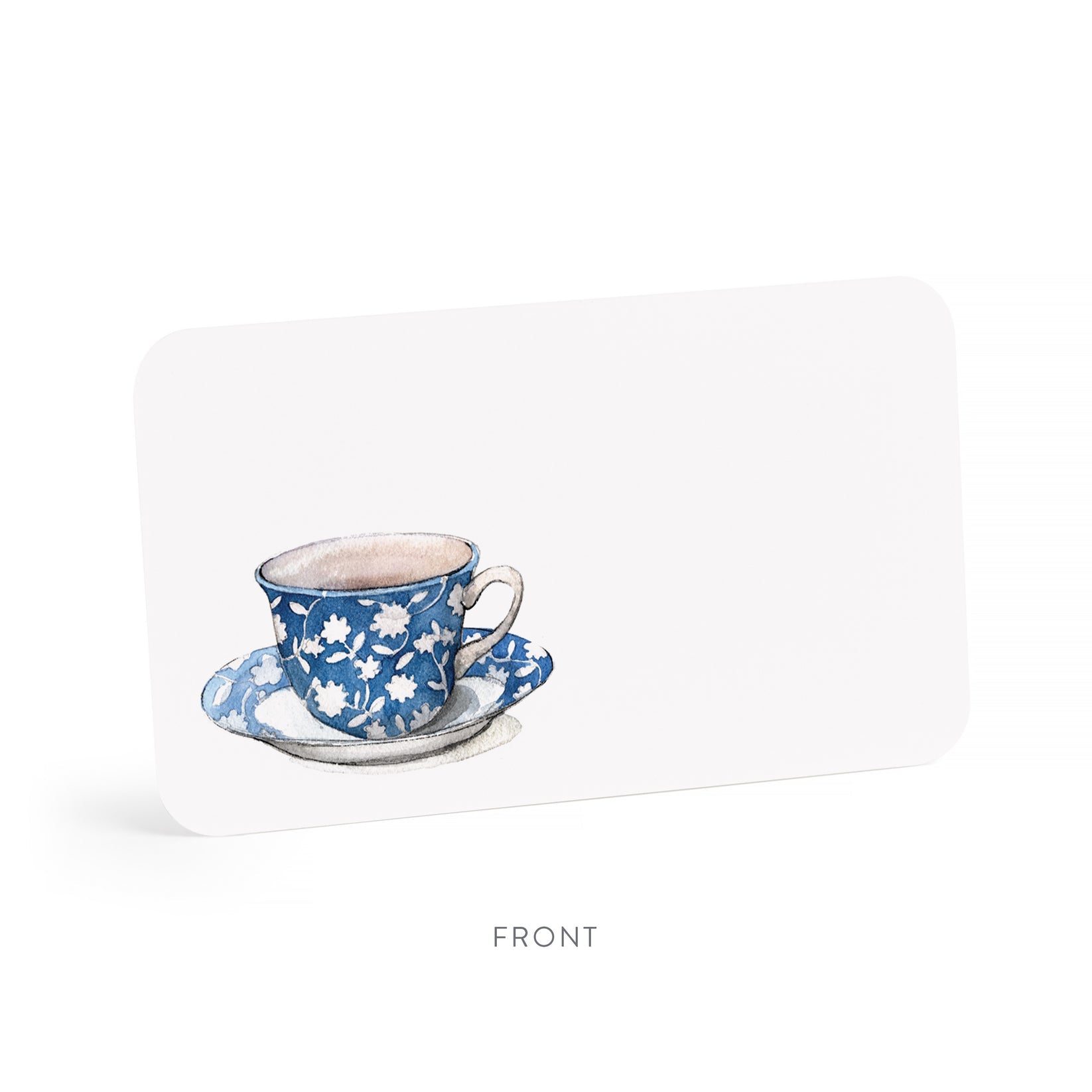Blue floral teacup and saucer on a white little note.