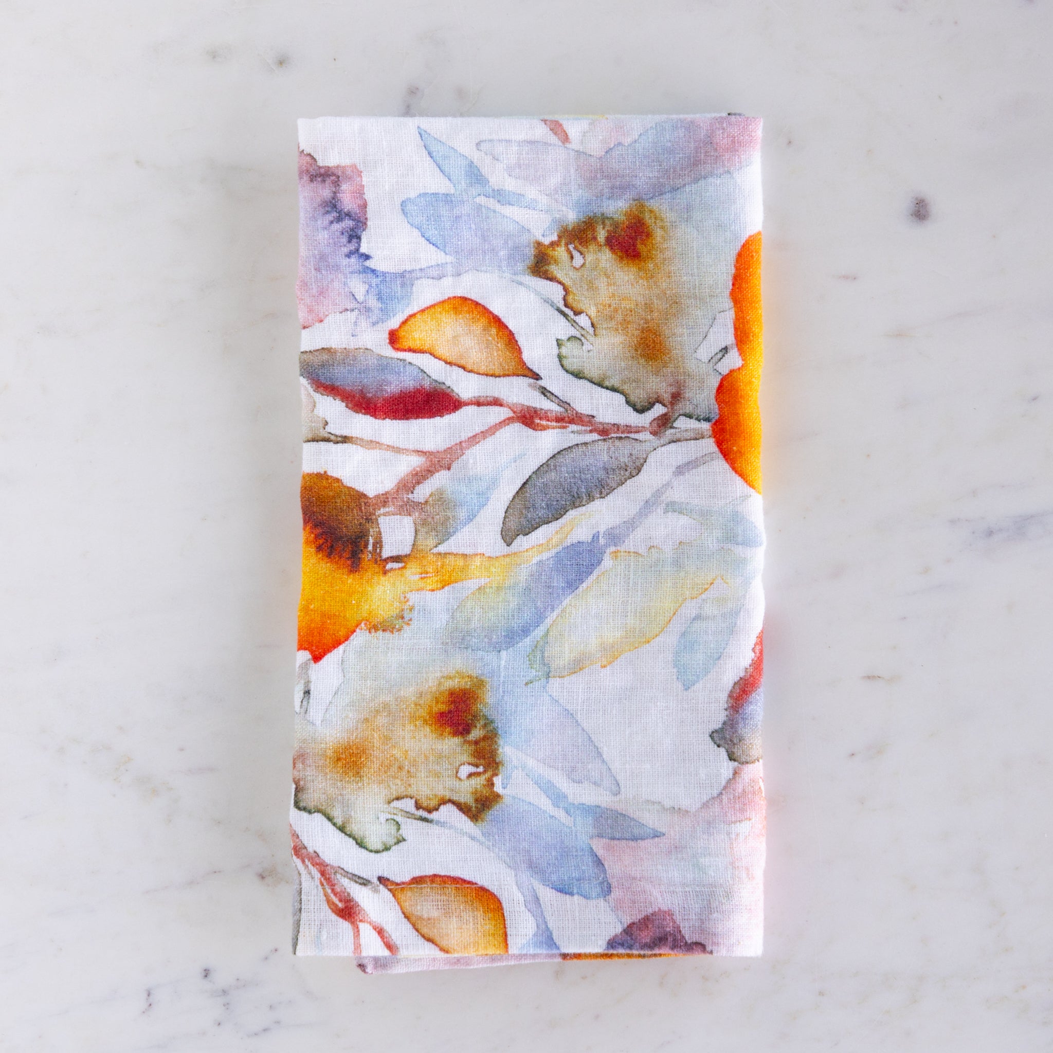 Floral patterned napkin on a marble surface.