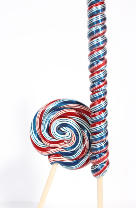 Two colorful lollipops on sticks with a white background