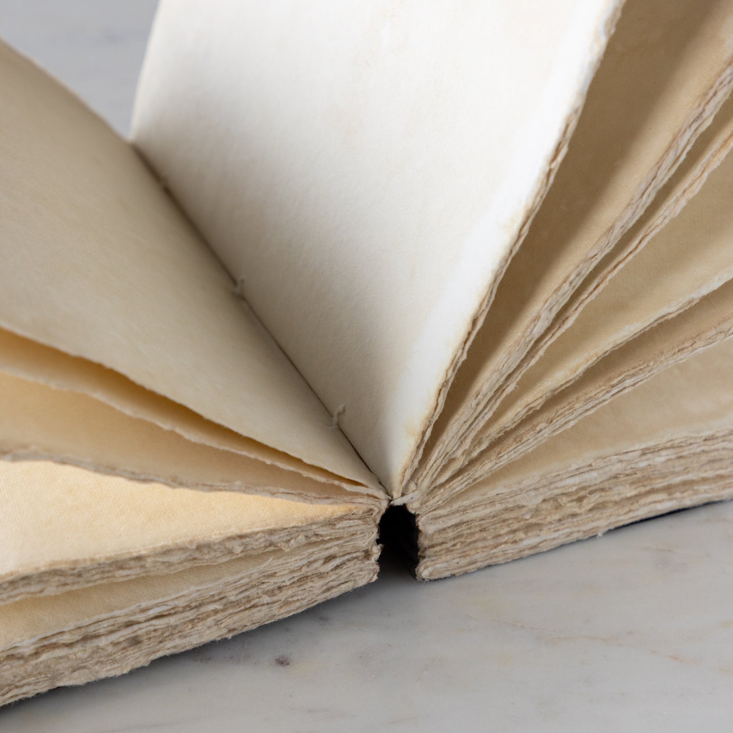 Open notebook with beige pages on a light background.
