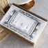 Theater Book of Secrets, a decorative storage box with a vintage illustration of a theater scene, on a marble table.