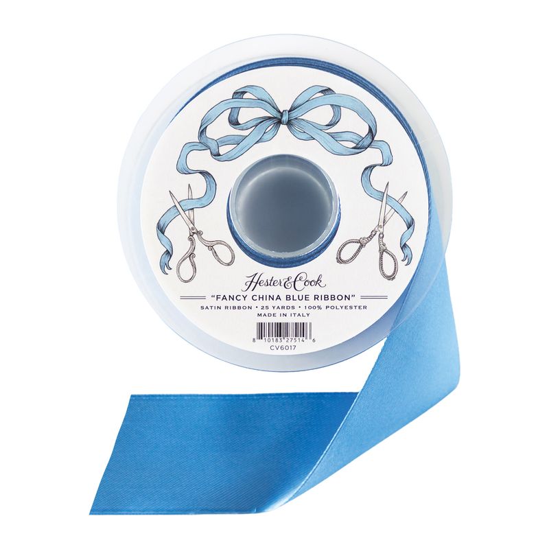 A spool of blue satin ribbon by Hester &amp; Cook on a white background.