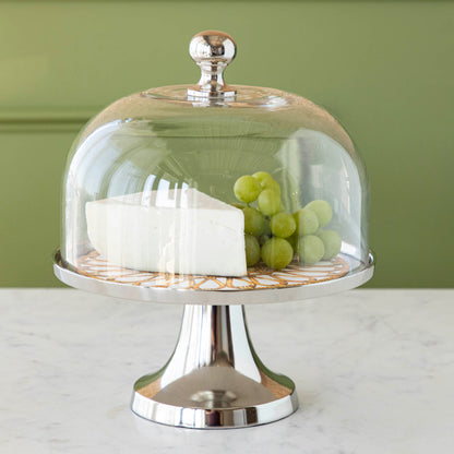 Aluminum serving stand with glass dome on white background