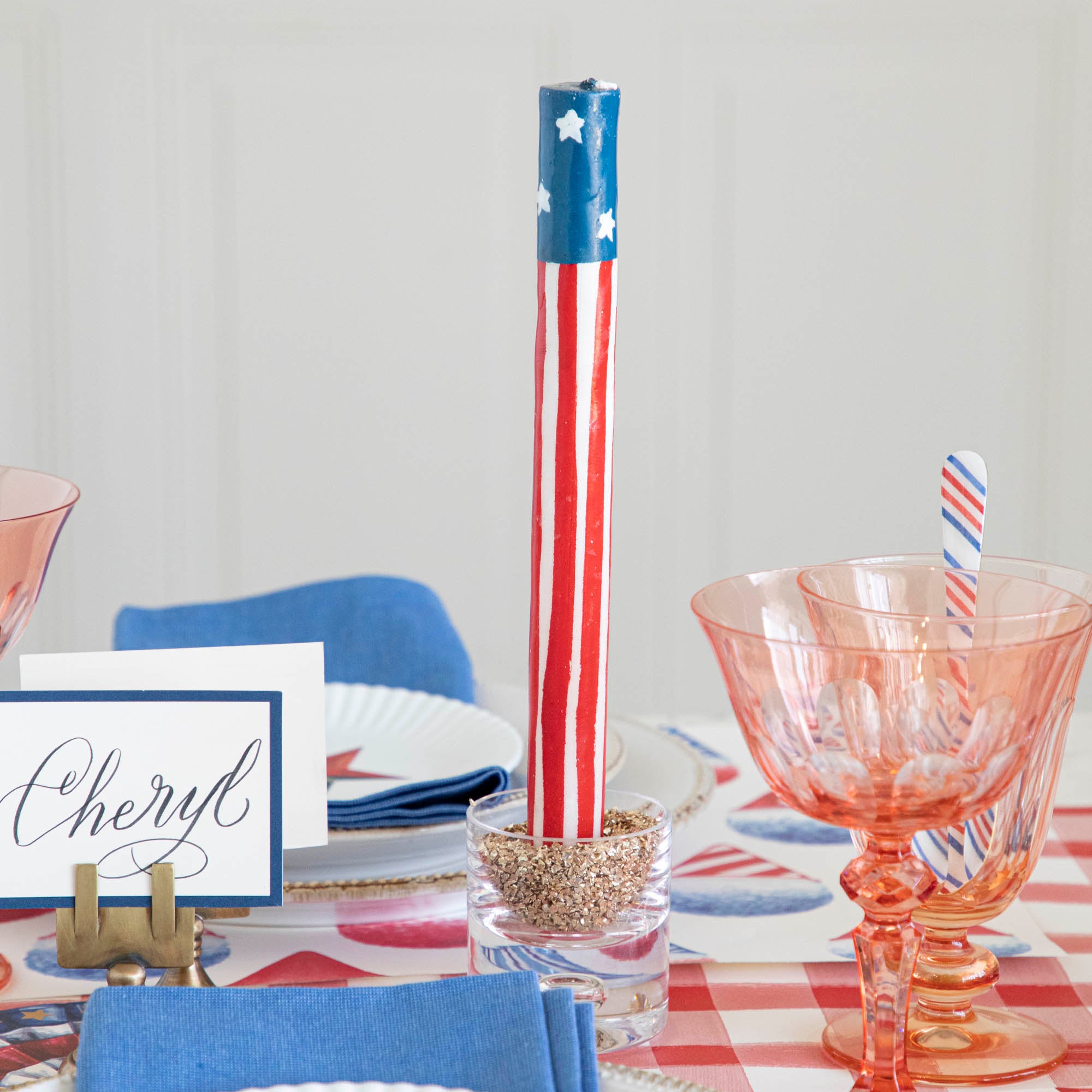 Two Star Spangled Taper Candles by Glitterville arranged in a cross shape, wrapped with a Stars &amp; Stripes-themed design.