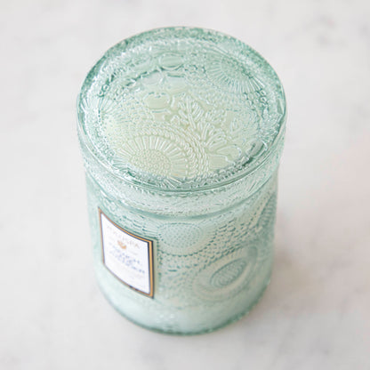 Two Voluspa French Cade Lavender candles on a marble surface with lemon verbena matchsticks.
