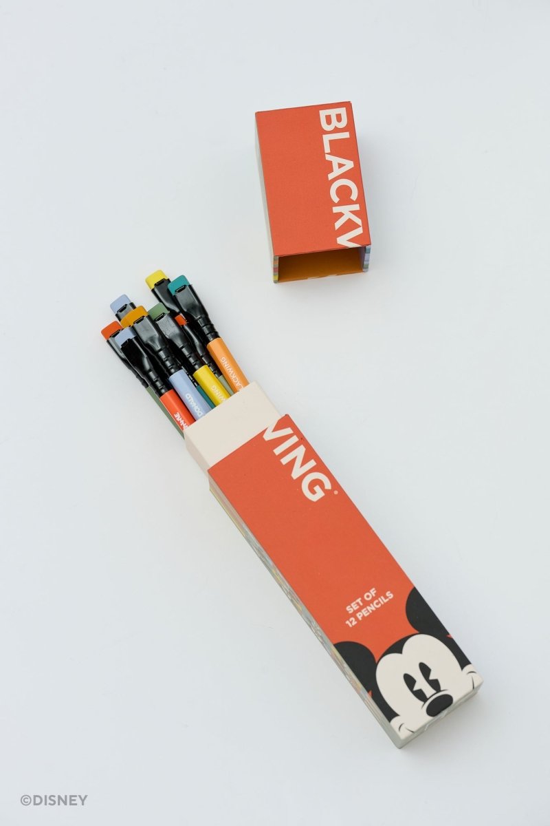 A set of Disney Blackly pens in a matching orange and white cardboard box, with the box lid placed above it on a clean white background.