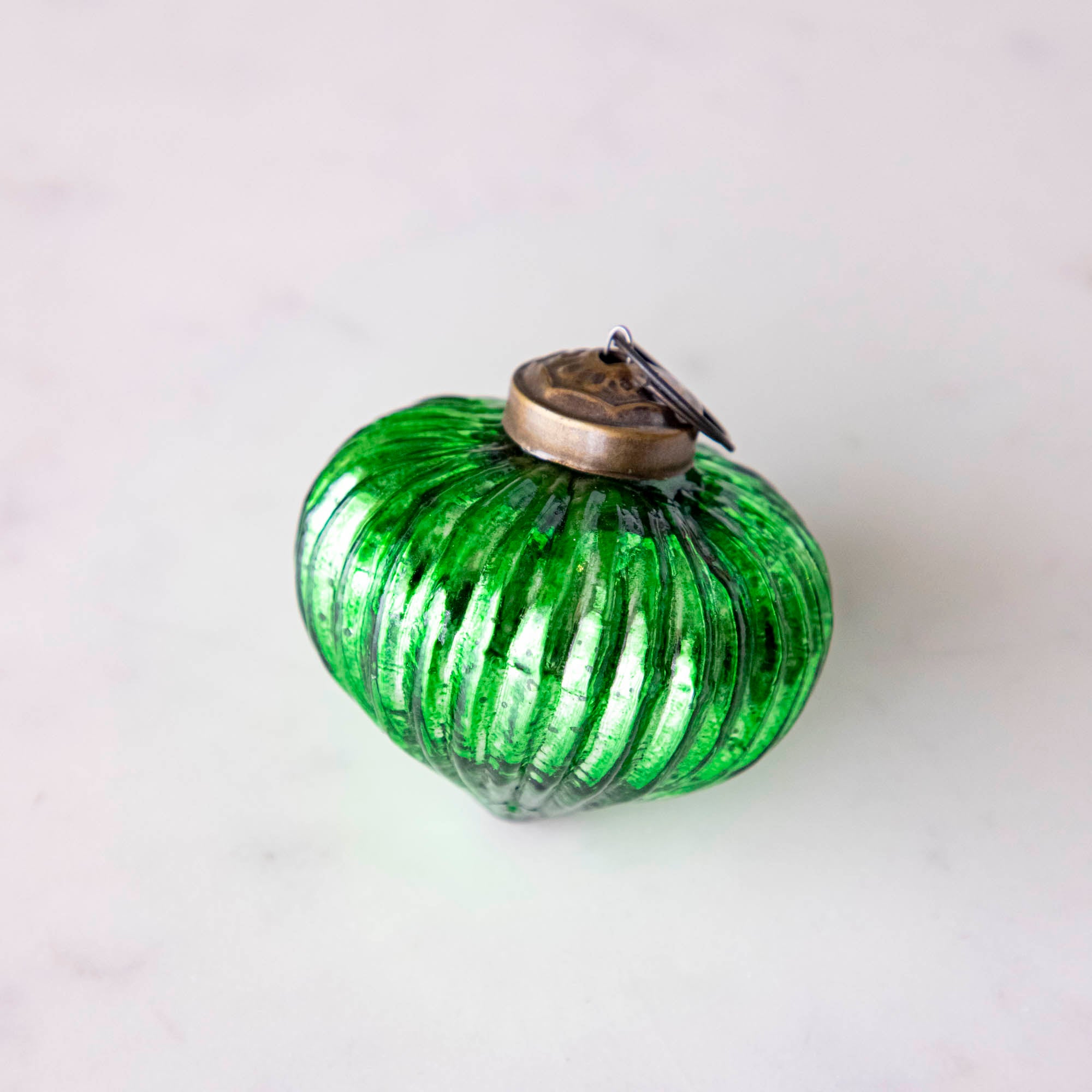 Mini green ribbed ornament.