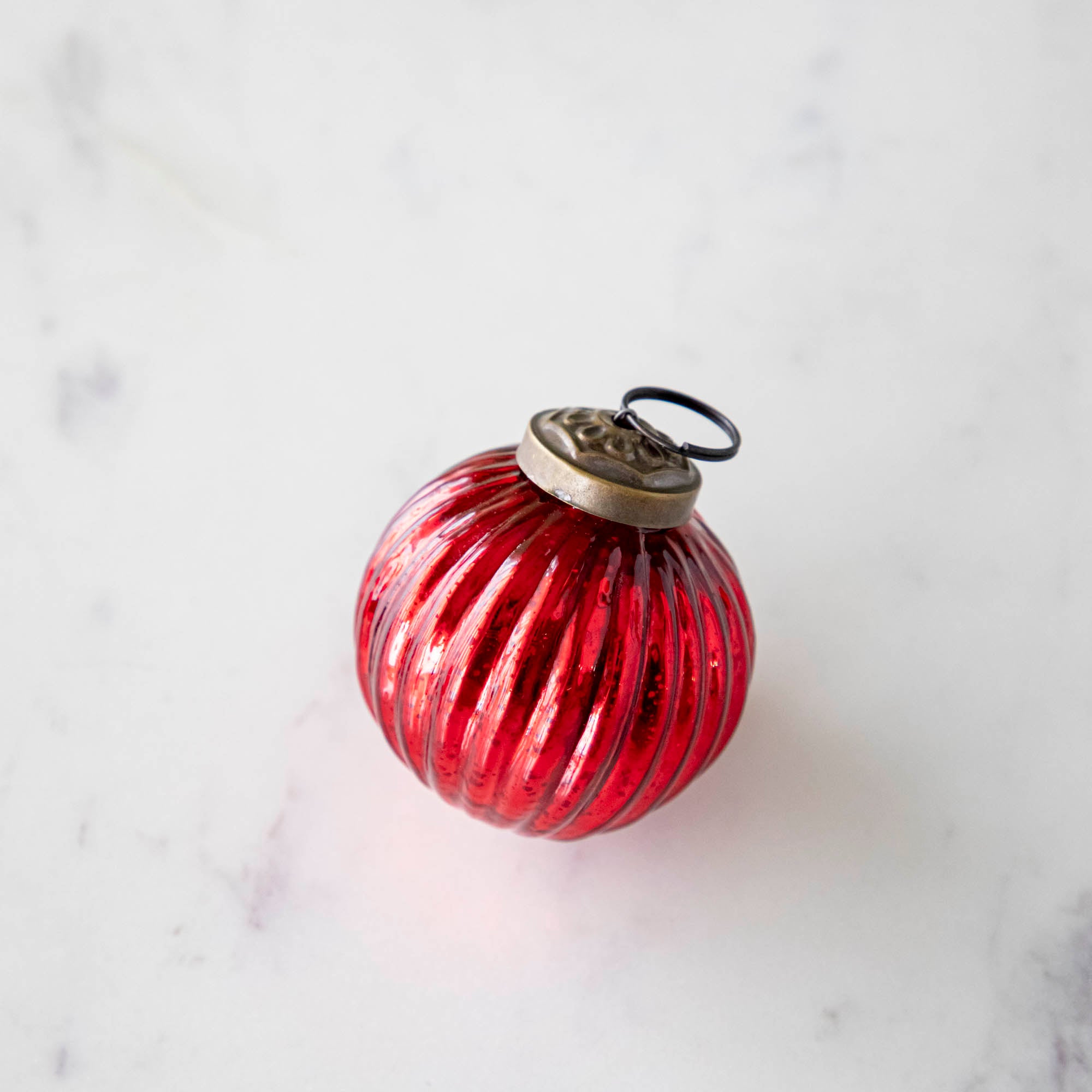 Mini red ribbed ornament.