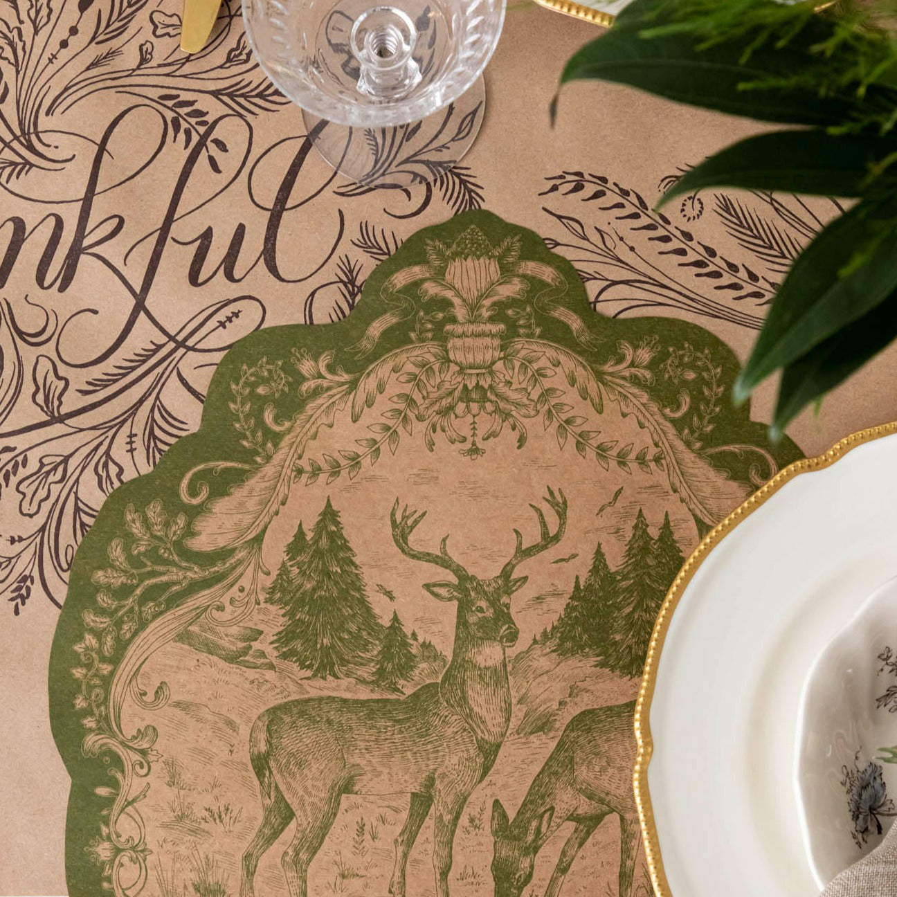 Close-up of the Die-cut Moss Fable Fauna Placemat under an elegant place setting.