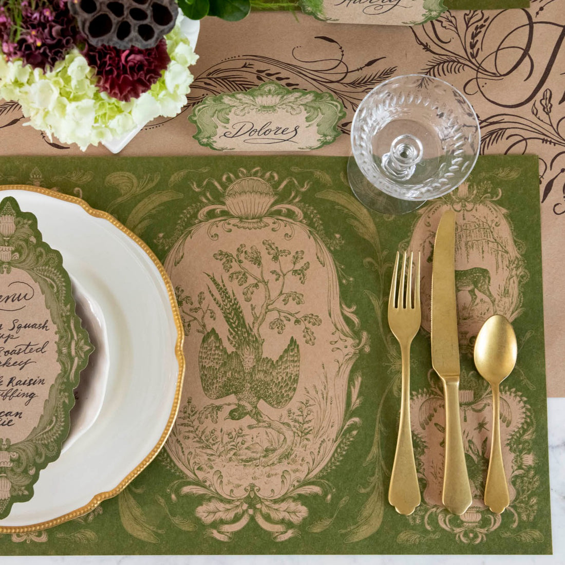 The Moss Fable Toile Placemat under a fall-themed place setting, from above.