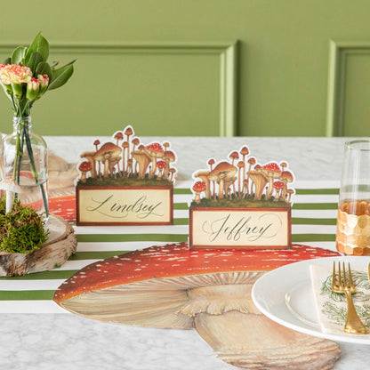 A table setting with elegant gold place settings next to a die-cut mushroom placemat.