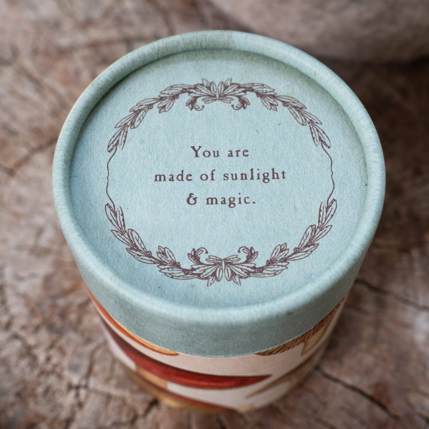 Cylindrical container with inspirational quote on it. 