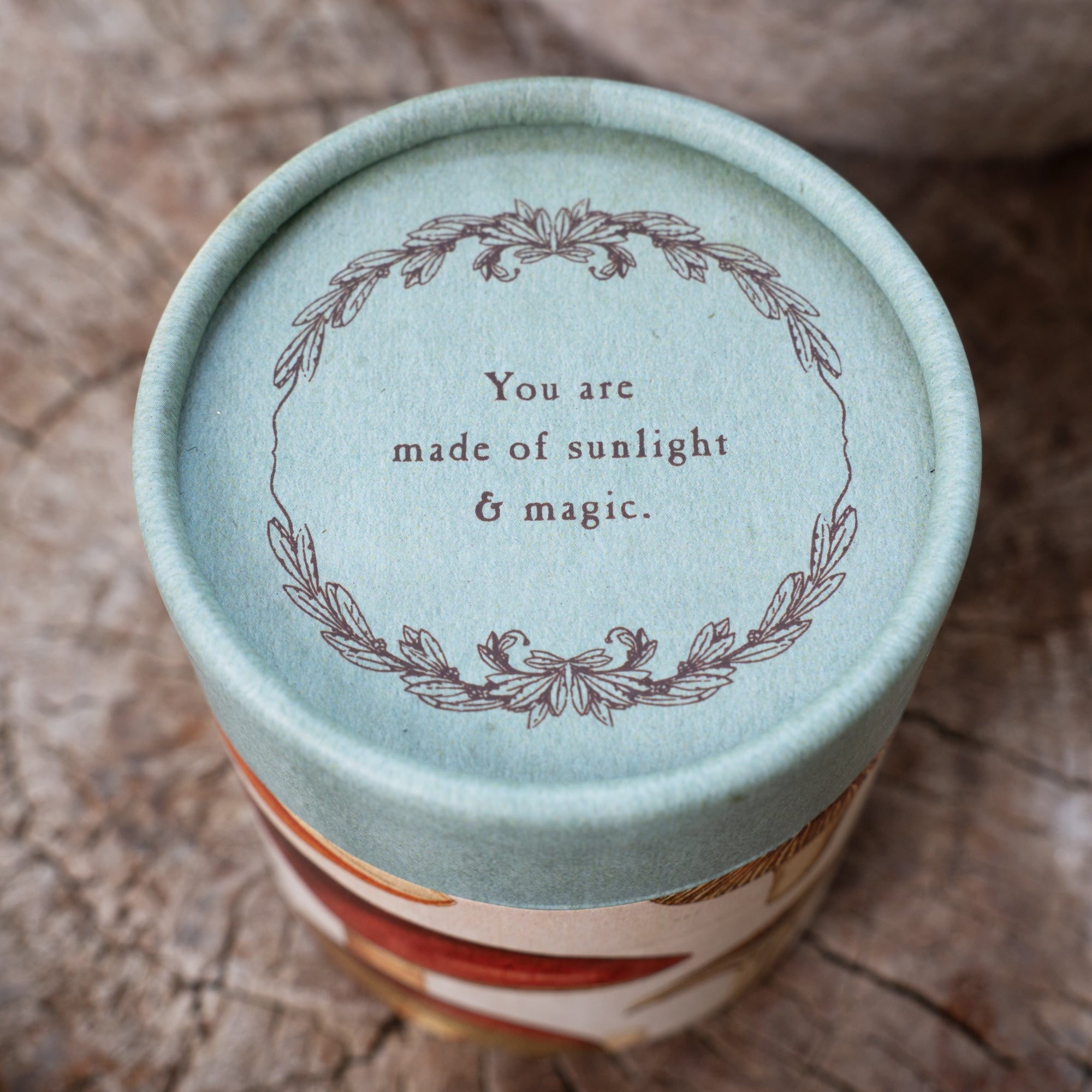 Cylindrical container with inspirational quote on it. 