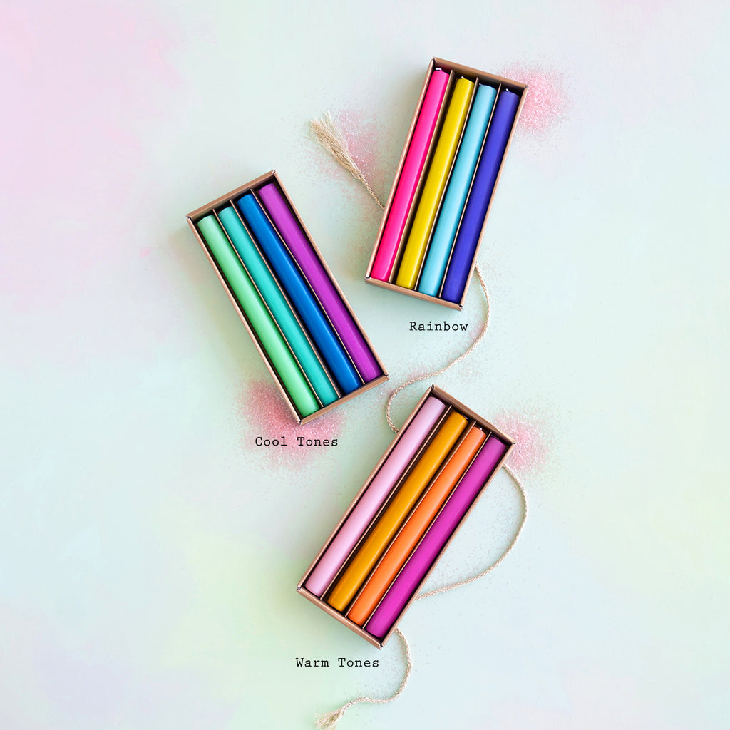 Four sets of colorful straws arranged diagonally with labels &quot;cool tones,&quot; a Rainbow Taper Candle Boxed Set of 4, and &quot;warm tones&quot; on a pastel background by Glitterville.